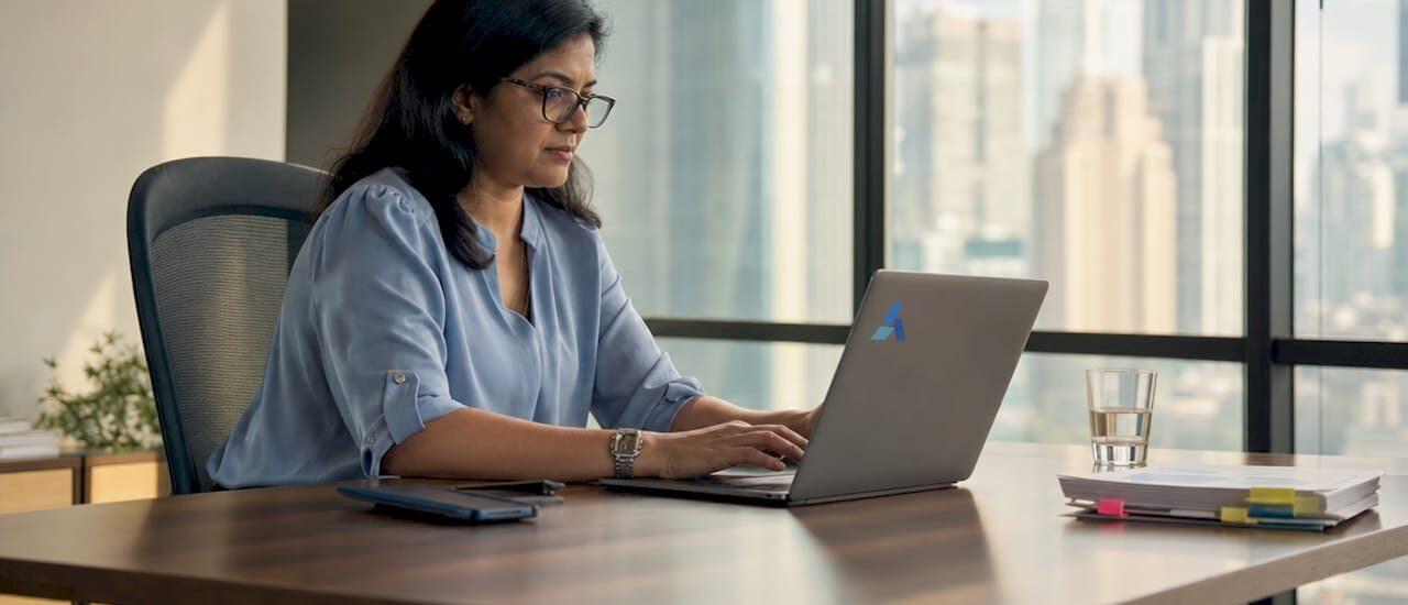 Businesswoman reviewing AI data insights on laptop