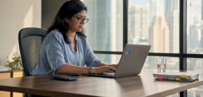 Businesswoman reviewing AI data insights on laptop