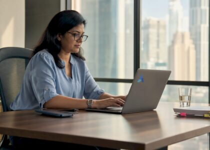 Businesswoman reviewing AI data insights on laptop