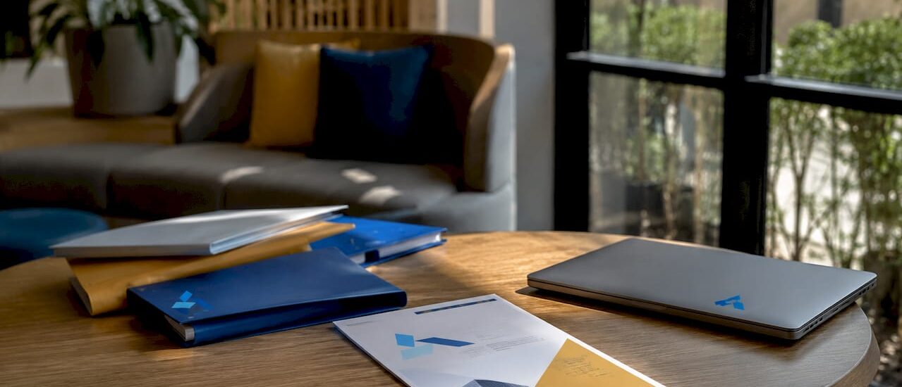 Overhead view of strategy documents and Blue Prysm logo
