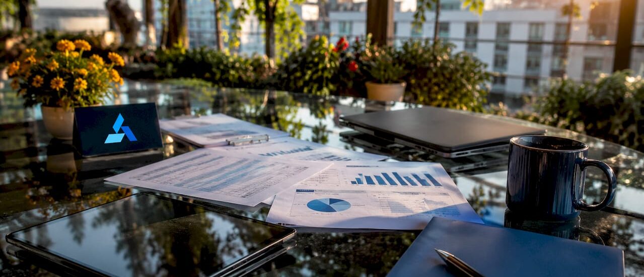 Business analyst workspace with Blue Prysm logo and data materials