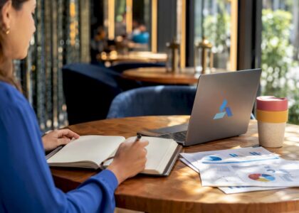 Workspace with notebook and Blue Prysm logo