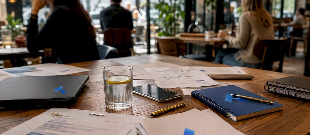 Workspace with strategic brief documents and Blue Prysm logo