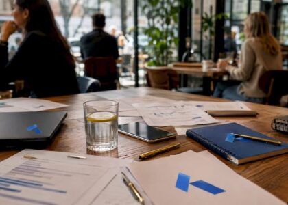Workspace with strategic brief documents and Blue Prysm logo