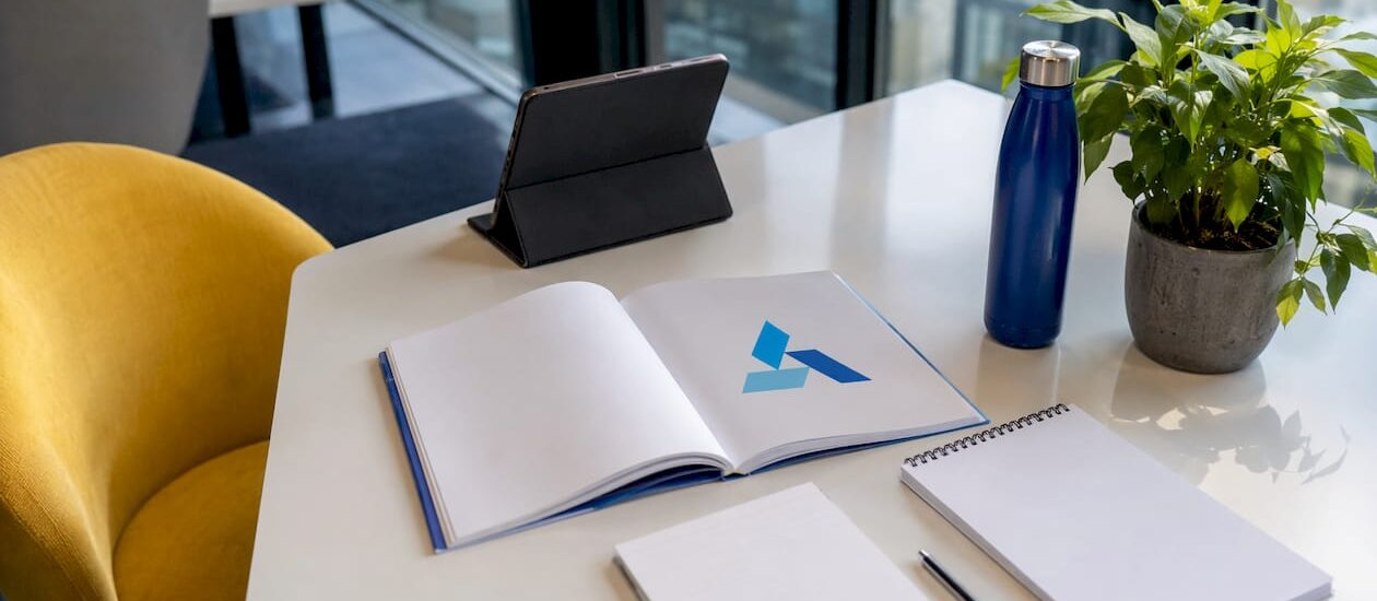 Business strategy workspace with Blue Prysm logo booklet