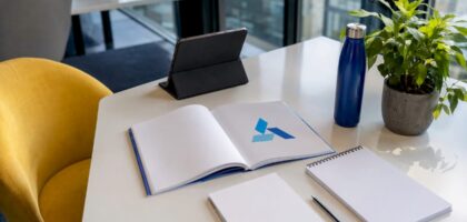 Business strategy workspace with Blue Prysm logo booklet