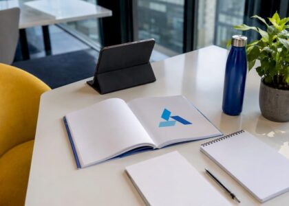 Business strategy workspace with Blue Prysm logo booklet