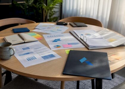 Desk with business planning materials and Blue Prysm logo