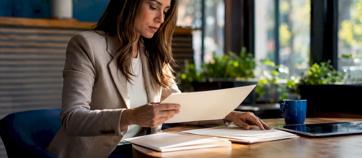 Hands organizing investment tax compliance folders