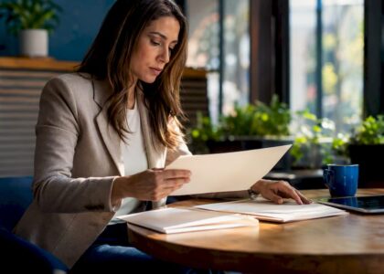 Hands organizing investment tax compliance folders