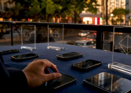Smartphones and Blue Prysm logos on table