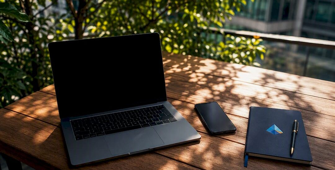 Modern workspace with devices and Blue Prysm logo