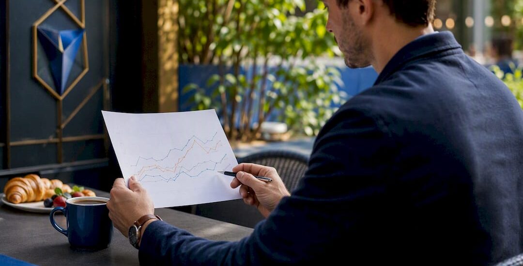 Hands analyzing market trend graph