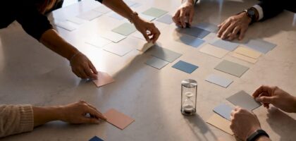 Hands arranging strategic roadmap initiatives